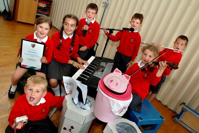 2006 - Pupils of Holy Family RC Primary School, New Springs, with prizes which they helped to win for the school by achieving the most pledges in the Recycling Rewards for Schools scheme. Trying out the equipment are Owen Moran, front, left to right, Katie Power, who collected the most pledges and won an MP3 player, Bethany Dove, Andrew Dean, Matthew Dean, Reece Roocroft and Mega Power.