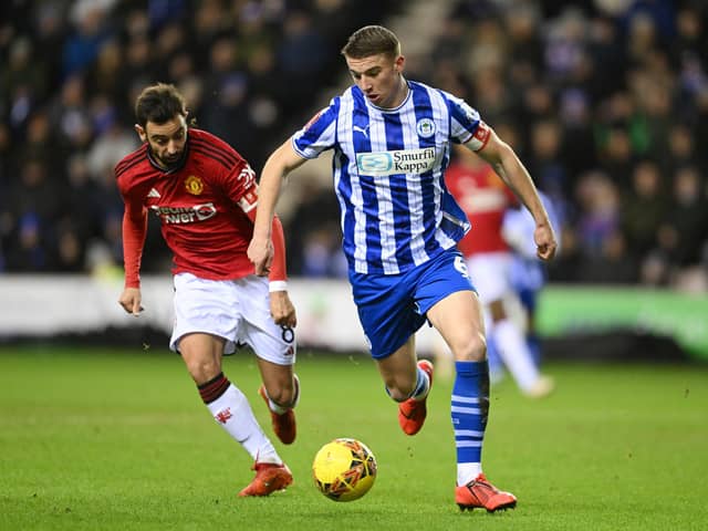 Wigan Athletic academy product Charlie Hughes has completed a move to Hull City