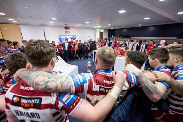 The Wigan team gather in the changing rooms after the match.