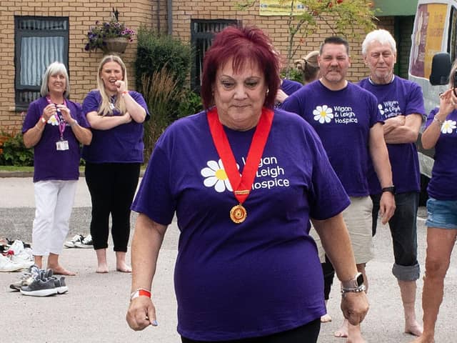 Former Mayor of Wigan Coun Debbie Parkinson braves the heat, at the fire walk event, held as part of the Garden Party at Wigan and Leigh Hospice.