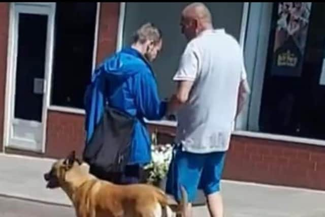 Ian and Roxy walking through Wigan town centre.