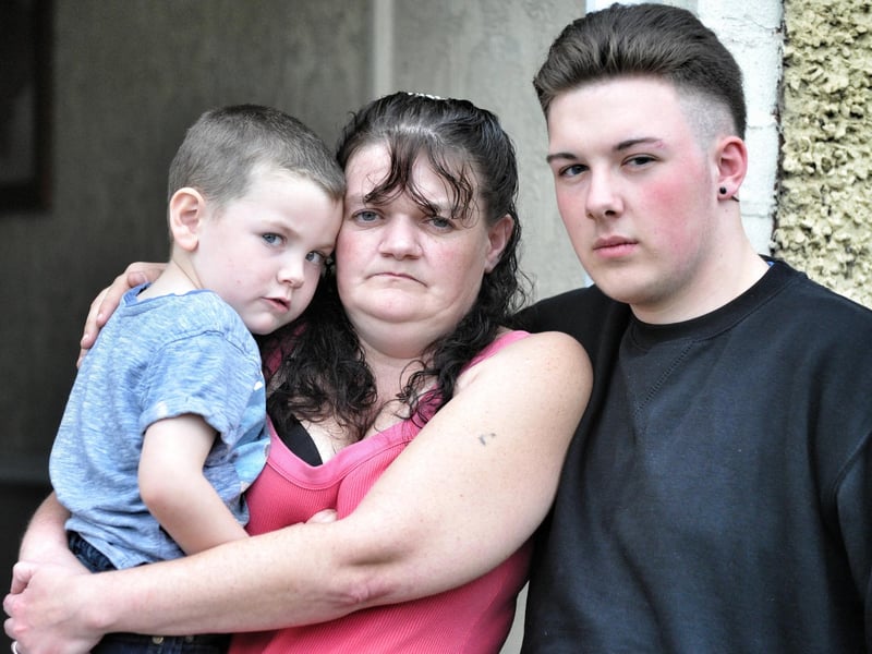Catherine Carter who ws a victim of scandal-hit tax credit firm Concentrix, pictured at her Abram, Wigan, home with sons Daniel and Callum
