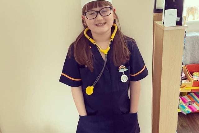 Mia, aged seven, dressed as an NHS nurse for the superhero day challenge.