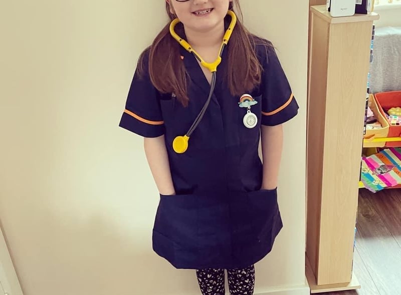 Mia, aged seven, dressed as an NHS nurse for the superhero day challenge.