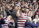 Wigan fans celebrate the victory over St Helens