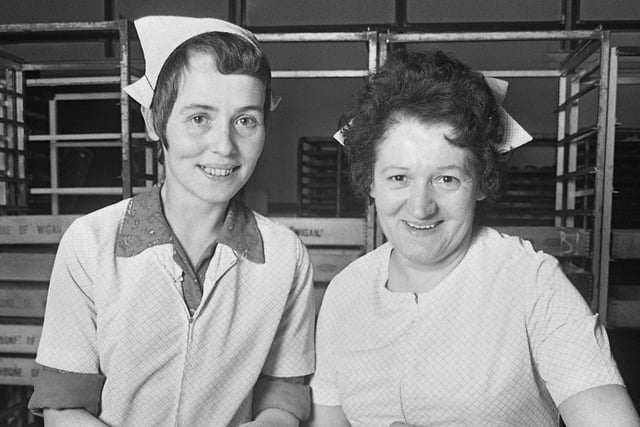 Eileen Nicholls, left, and Nellie Johnson confectioners in the cake finishing and packaging department.