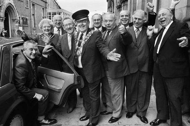 Role reversal for retiring mayor's chauffeur Harry Liptrot as he arrives for a presentation at Wigan Town Hall on Monday 30th of January 1989.
Mayor, Councillor David Caley, holds the door open for him as he is greeted by former mayors who he had driven around on their duties for the past 18 years.