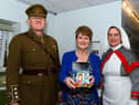 Author Rhona Whiteford with Major Alan Taberner and Major Linda Taberner from the Medical Living History Group with her new book A Legacy of Ghosts