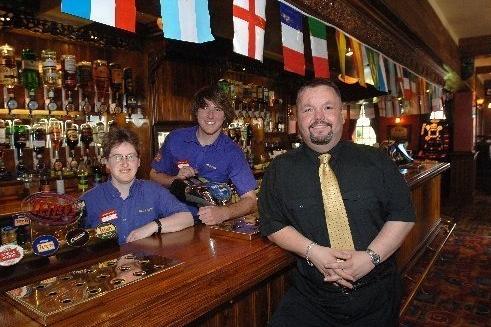Darren Todd, right, landlord of The Red Robin Pub, Robin Park, Wigan, with bar staff Dee Todd, and Bill Adams, 2006.