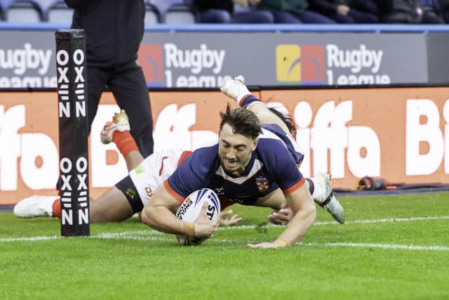 England's Matty Ashton scores a try against Tonga.