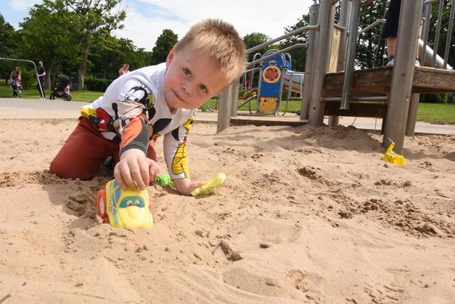 Theo Slawson, three, enjoys the sand at the play park in Mesnes Park, Wigan.