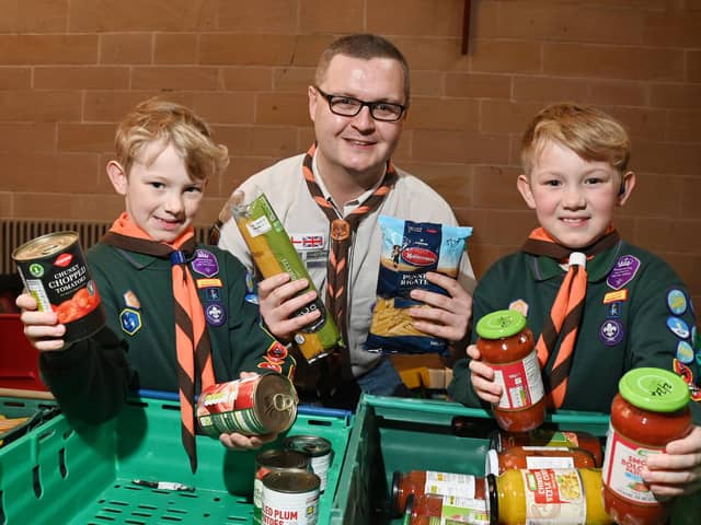 Cub Scouts Josh and Oliver Seddon, seven, with leader David Simpson