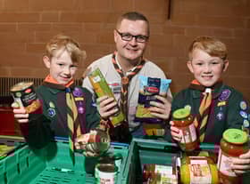 Cub Scouts Josh and Oliver Seddon, seven, with leader David Simpson