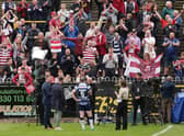 Wigan fans celebrate following the victory over Castleford Tigers