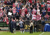 Wigan fans celebrate following the victory over Castleford Tigers