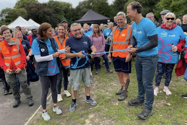 Sky Sports presenter Phil Clarke, right, cuts the ribbon for the start of the event with Coun Chris Ready (centre) at Haigh Woodland Park.