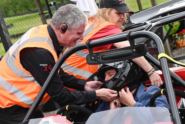Speed of Sight founder Mike Newman, left, assists Australian visitor Ben Felten, the world's fastest blind man on a motorcycle, in 2018, pictured at Three Sister Race Circuit, Ashton-in-Makerfield.