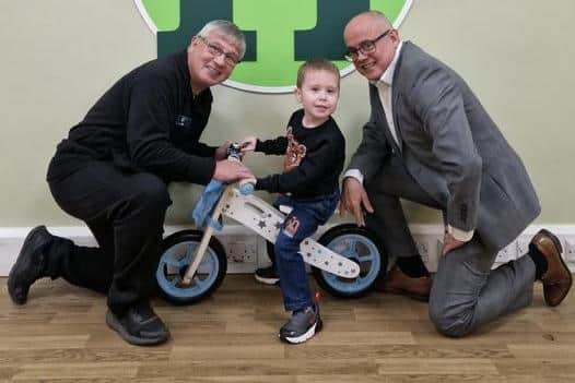 Three-year-old Jayden Walsh pictured with CJ Ice Cream boss Colin Jamieson (left) and Haigh Woodland Park general manager Keith Bergman (right)
