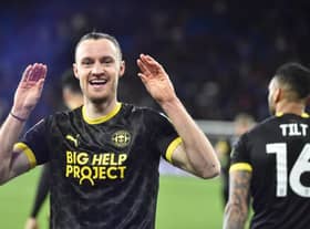 Will Keane celebrates his last-gasp leveller at Cardiff