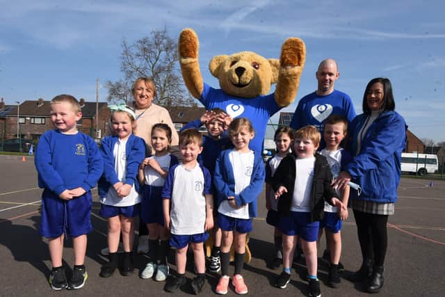 Staff and pupils at Newton Westpark primary school, Leigh, take part in a fund raising run, completing a mile around the school playground, to show support for former pupil Michael O'Dwyer, who has survived Cancer and is preparing to take part in the London Marathon, raising funds for The Christie, where he was treated.