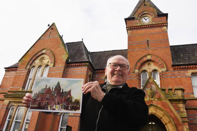Coun George Davies outside Wigan Infirmary as he works on a booklet to celebrate its 150th anniversary