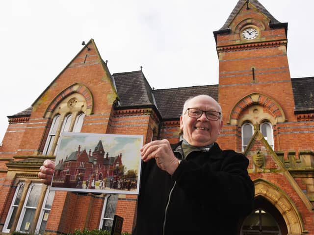 Coun George Davies outside Wigan Infirmary as he works on a booklet to celebrate its 150th anniversary