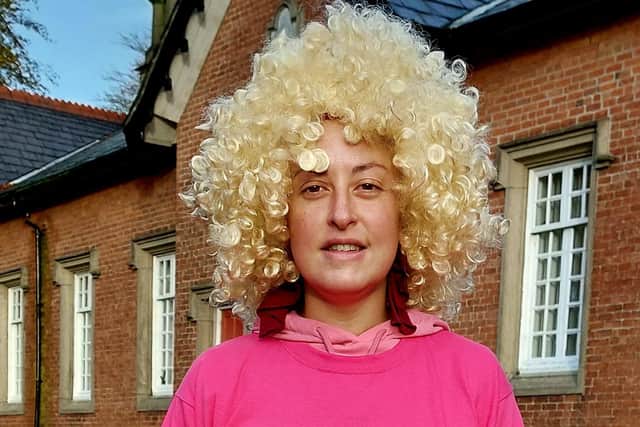 Angela wearing a wig and her Breast Cancer Now charity T-shirt.