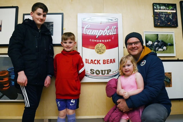 Ben Winstanley with George, 11, Thomas, seven and Elizabeth, three, next to Andy Warhol Black Bean - 1968 part of Soup Can Series I.