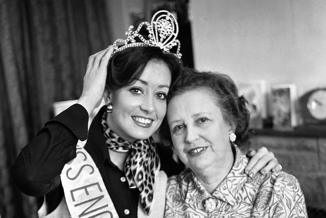 Pauline Davies at home with her mum in Lowton just after winning the Miss England 1976 title in March. Pauline was a draughtswoman until leaving to become a full time successful photographic fashion model. She went on to win many beauty titles around Britain. After winning the Miss England title she was a semi-finalist in the Miss Universe contest.  She also appeared in many television programmes during her career including "The Generation Game", It's a Knockout", Pebble Mill at One" and "Come Dancing".  Pauline went on to become a well known watercolour artist doing commercial work and private commissions.