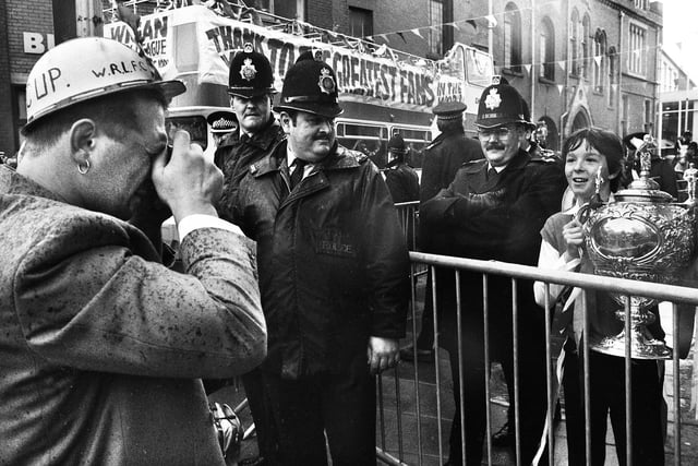 Wigan hooker Nicky Kiss obliges a young fan by taking his picture with the Challenge Cup as the team bus arrives at Wigan town hall for a civic reception on Sunday 1st of May 1988 after their Wembley triumph. 