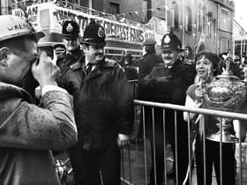 Wigan hooker Nicky Kiss obliges a young fan by taking his picture with the Challenge Cup as the team bus arrives at Wigan town hall for a civic reception on Sunday 1st of May 1988 after their Wembley triumph. 
