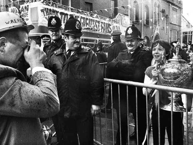 Wigan hooker Nicky Kiss obliges a young fan by taking his picture with the Challenge Cup as the team bus arrives at Wigan town hall for a civic reception on Sunday 1st of May 1988 after their Wembley triumph. 