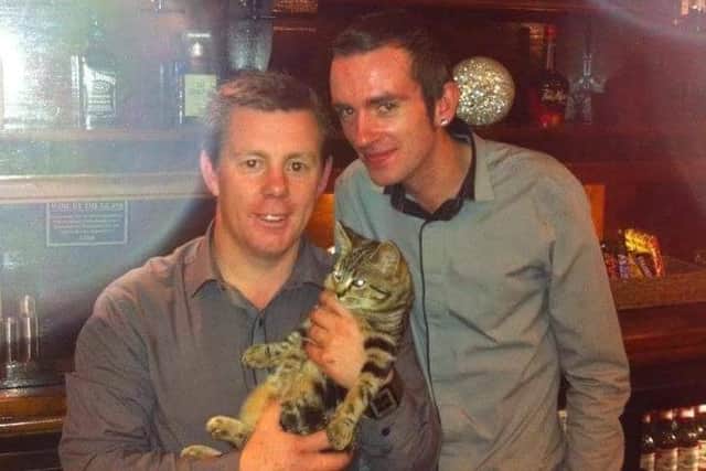 Dean Prescott (left) with partner Stephen James and their beloved cat Dora