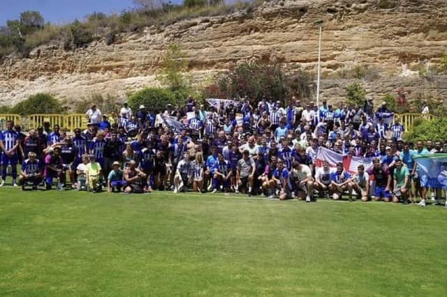 The Latics players and fans get together for a team photo in Campoamor