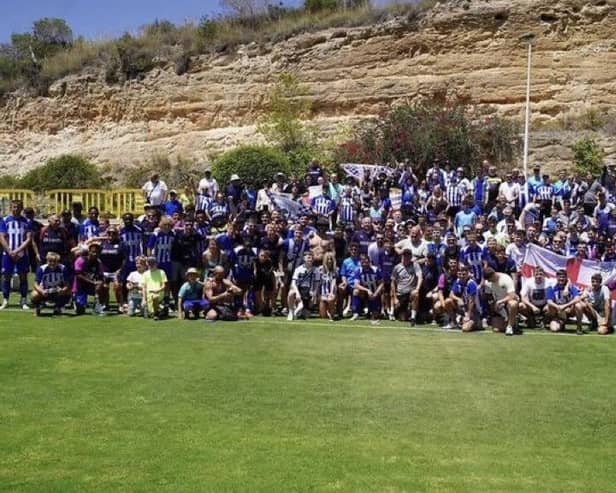 The Latics players and fans get together for a team photo in Campoamor