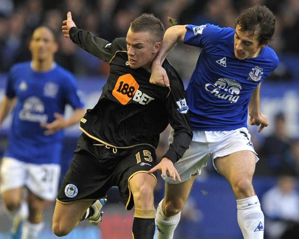 Leighton Baines, seen here in Everton colours battling Latics' Tom Cleverley, is now in joint-interim charge of Everton