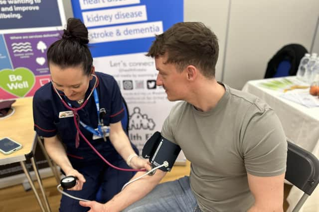 Coun Fletcher having his blood pressure check