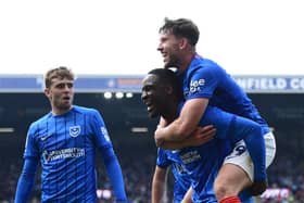 Callum Lang and Christian Saydee celebrate a Portsmouth goal last season