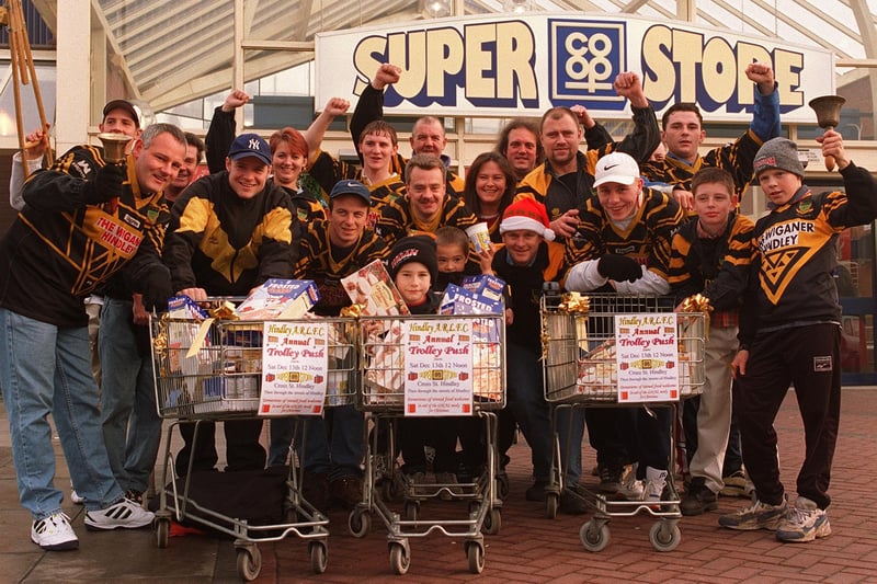 Members of Hindley ARLFC for their Annual Trolley Push.  The club collected food for the needy for Christmas, and were kindly started off by the Co-Op Supermarket, who also supplied the vehicles!