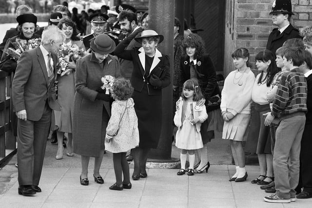 A big moment for a little girl.....she dashed out of the crowd on the Heritage Centre forecourt to present a posy to the Queen, during her visit to Wigan in 1986.