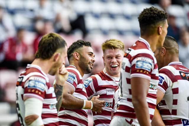 Bevan French celebrates with his teammates after scoring his seventh try