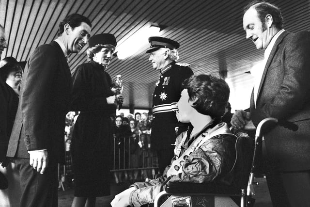 Prince Charles and Princess Diana chat to Stephen Hooton and his proud dad Jim as they arrive at Wigan North Western station on route to Skelmersdale in 1986.