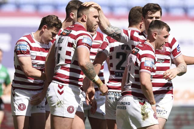Wigan Warriors celebrate Kaide Ellis' first try for the club