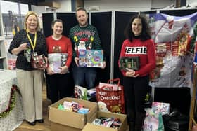 Maureen Holcroft, CEO of Daffodils Dreams, takes receipt of gifts from staff at Land of Beds