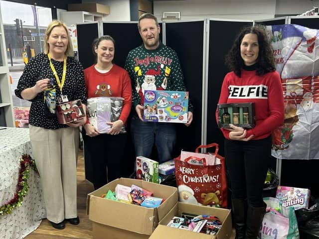 Maureen Holcroft, CEO of Daffodils Dreams, takes receipt of gifts from staff at Land of Beds