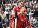 Charlie Wyke is mobbed by Tom Pearce after opening the scoring at Derby