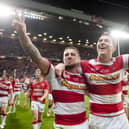 Wigan will face Hull FC in a pre-season match next year in the testimonial match for former player Scott Taylor, pictured above celebrating the 2013 Grand Final victory alongside Michael McIlorum