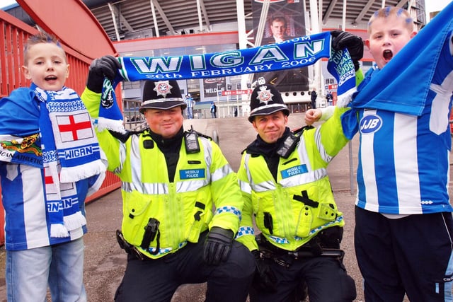 Connor Robinson and John Banks get support from Sgt Paul Mahoney and PC Lee Webber at the Carling Cup Final between Wigan Athletic and Manchester United at the Millennium Stadium, Cardiff, on Sunday 26th of February 2006.