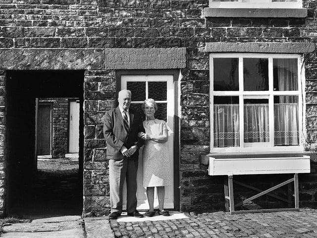 Peter and Mary Ashcroft outside their 100 year old cottage in Townsends Yard, off St. James Road, Orrell, in October 1971.