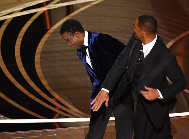 Will Smith (R) slaps US actor Chris Rock onstage during the 94th Oscars at the Dolby Theatre in Hollywood